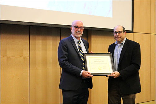 Featherstone receives his plaque as the next Faculty Research Lecture in Translational Science recipient from Stuart Gansky, MS, DrPH, Chair of Committee on Research